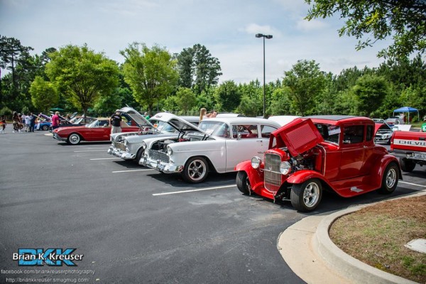 row of classic cars and hotrods at summit racing car show