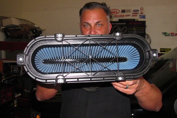 man holding a corvette air filter box