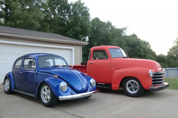 a vintage chevy 3100 truck and vw beetle bug