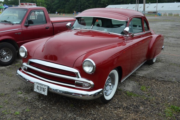 postwar chevy lowrider coupe with solid red paint