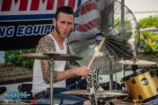 Drummer playing rockabilly music during a cruise-in car show
