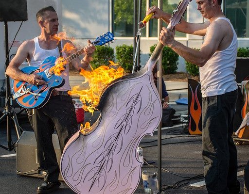 Musicians playing rockabilly music during a cruise-in car show