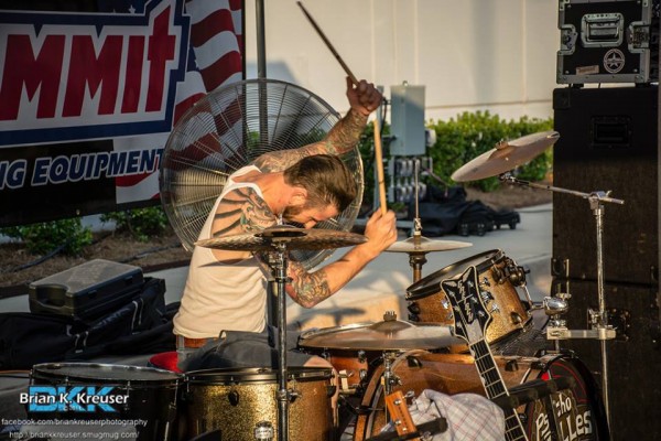 drummer playing rockabilly music during a cruise-in car show