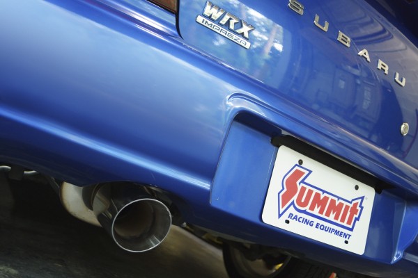 rear view of a subaru wrx muffler tip and bumper