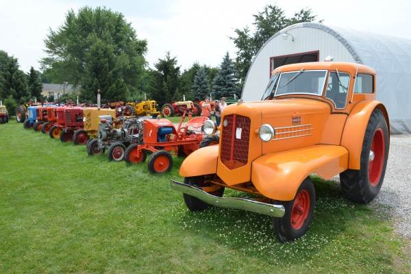 row of vintage tractors with Minneapolis moline UDLX at an antique farm equipment show