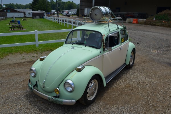 vintage VW Beetle with a beer keg on its rooftop luggage rack