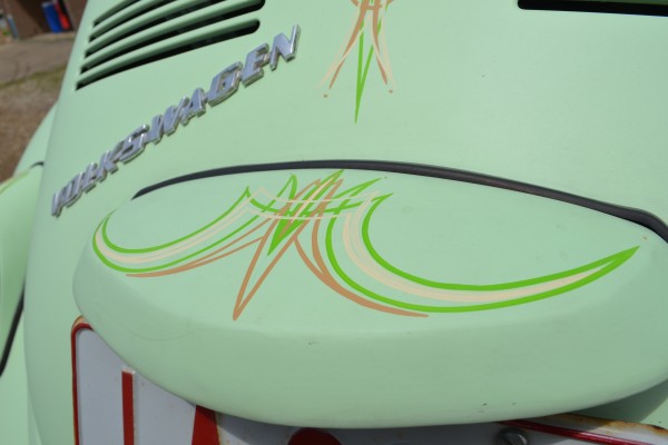 close up of custom pinstriping on the back of a vintage VW beetle