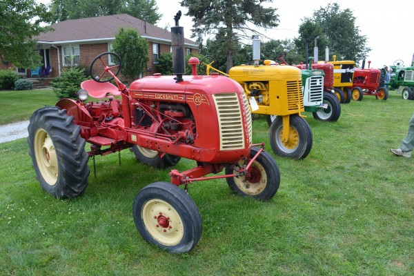 row of vintage tractors at an antique farm equipment show