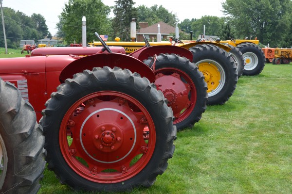 row of vintage tractors at an antique farm equipment show