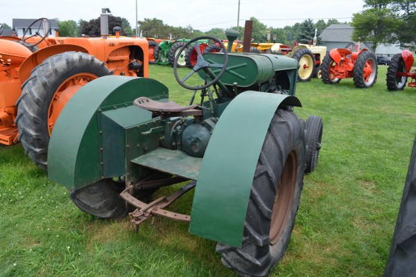vintage green tractor at an antique farm equipment show