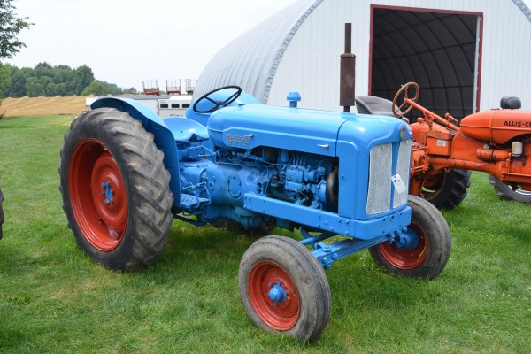 vintage blue tractor at an antique farm equipment show