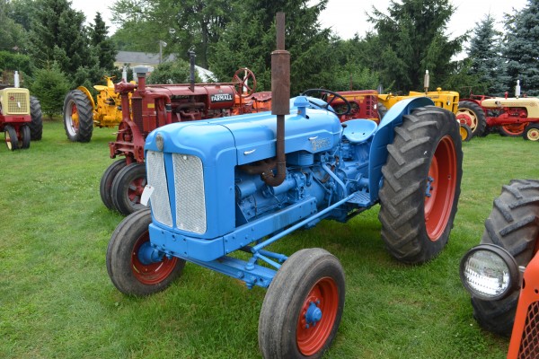 vintage blue farm tractor at an antique farm equipment show
