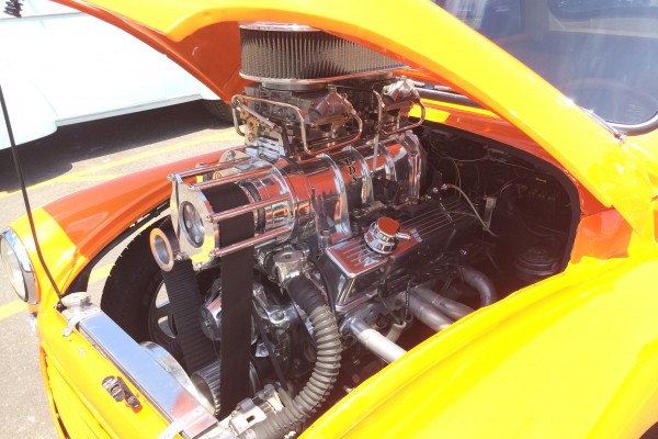 supercharged v8 engine under the hood of a hot rod