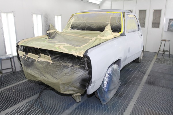 a truck cab in spray booth, primered and masked for paint