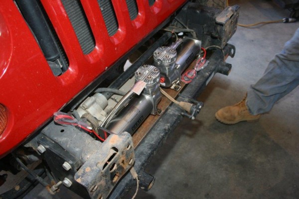 air compressors getting installed on a jeep wrangler bumper mount