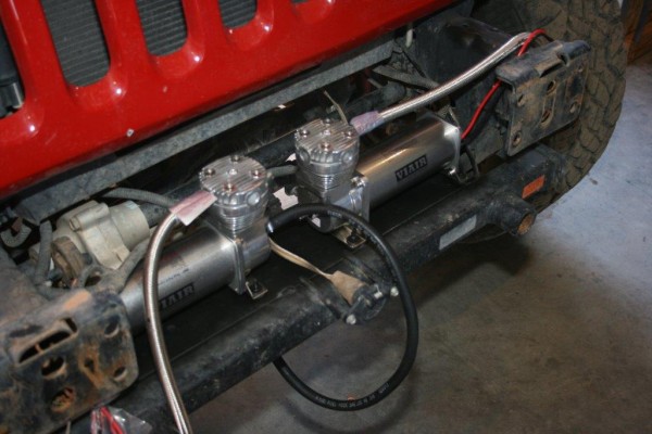 air compressors mounted on front of a jeep wrangler jk