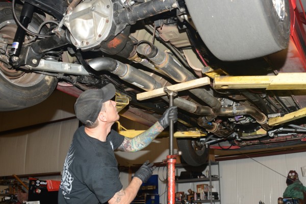 slowly lowering an exhaust system prior to full removal