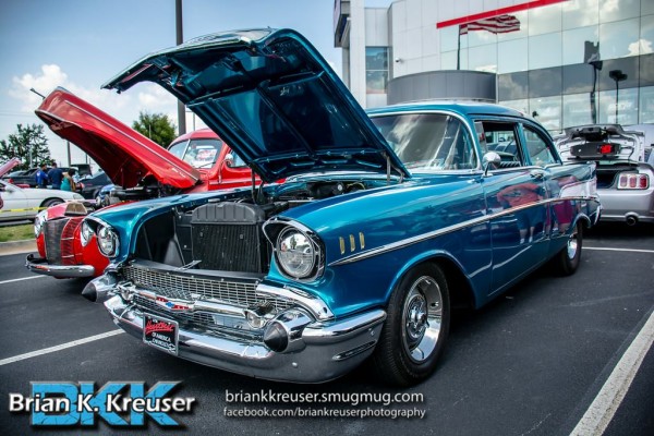 blue 1957 chevy bel air at a car show