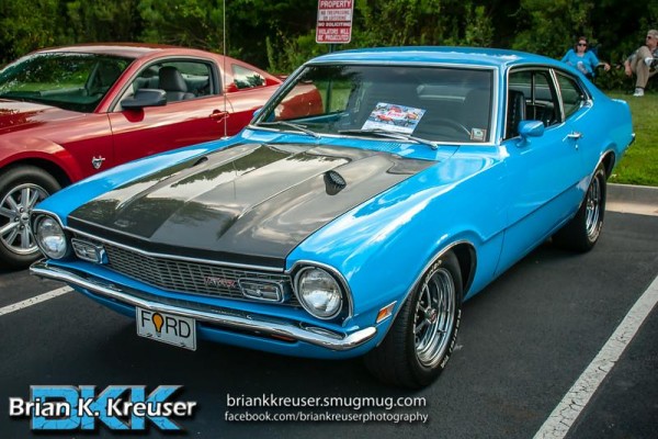 vintage ford maverick coupe at a summit racing car show