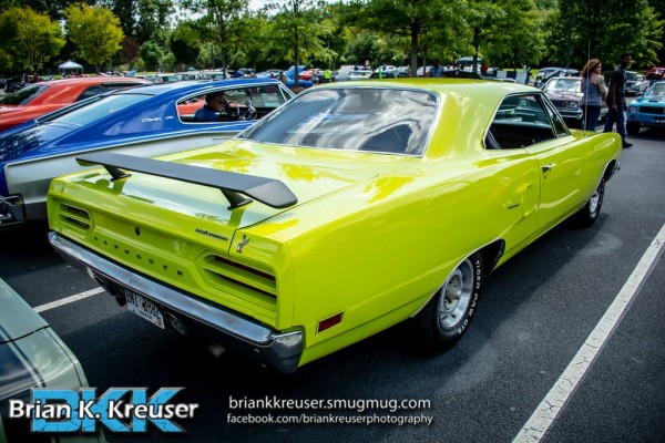 green plymouth roadrunner at a car show