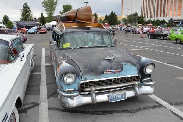 1955 chevy wagon with a canoe on its roof rack