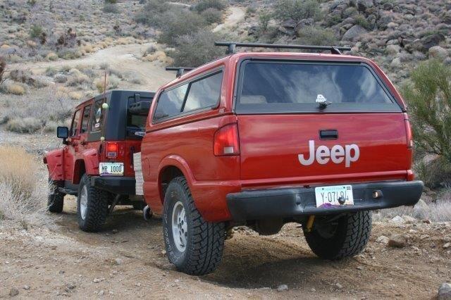a jeep pulling a custom made jeep trailer