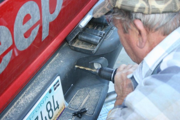 drilling a hole into a jeep bumper