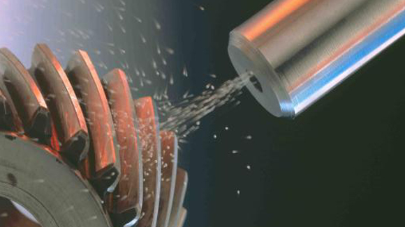 close up of machine shot peening a helical gear