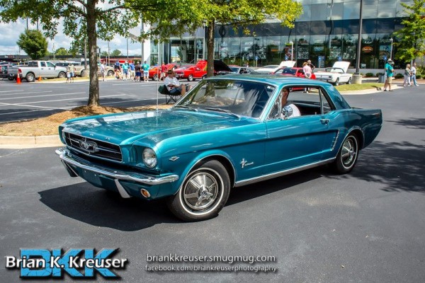 early 289 notchback ford mustang at car show