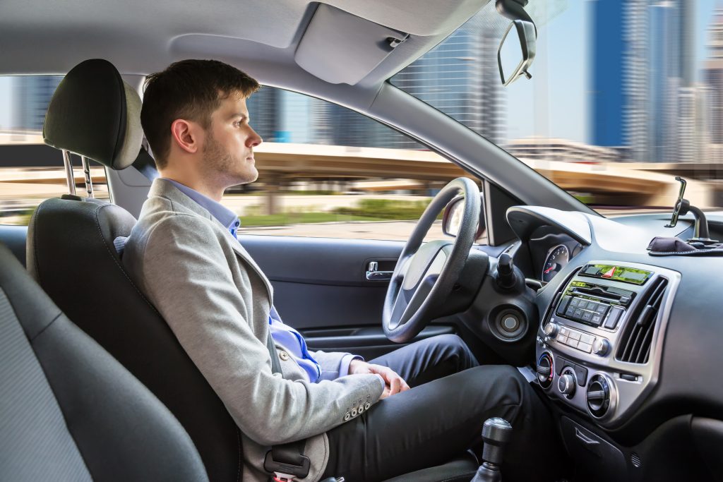 Man Sitting in an Autonomous Car while it self drives