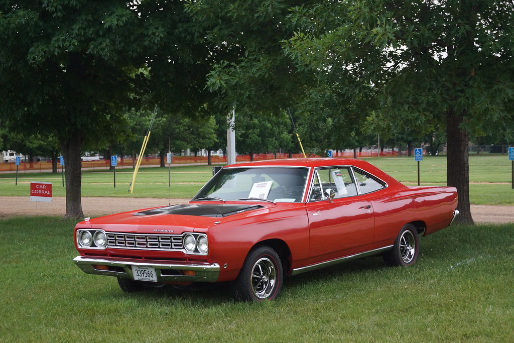 red plymouth gtx parked on grass