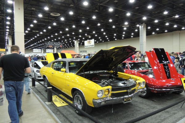 a yellow Chevy Chevelle at an indoor car show