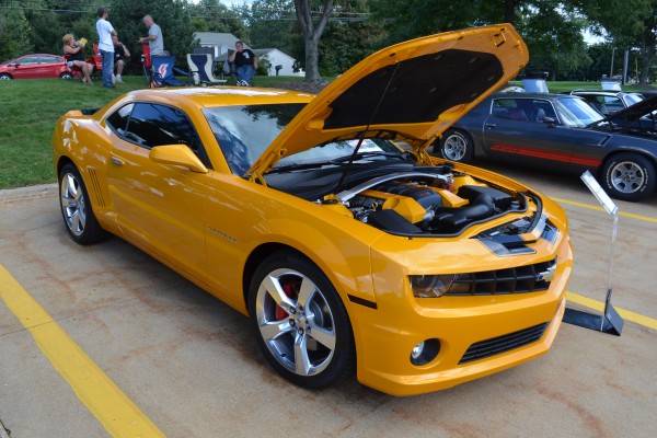 yellow chevy camaro late model at car show