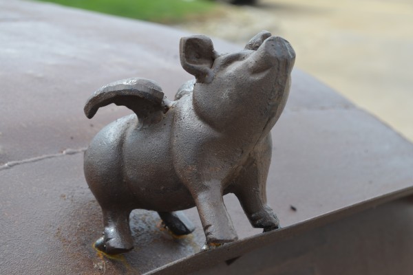 a pig sculpture welded onto a rat rod