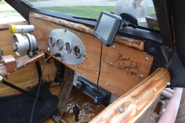 gene winfield autograph on the wooden dash of a rat rod