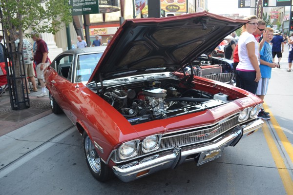 red second gen Chevy Chevelle parked on reno street during hot august nights