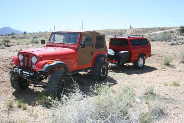 jeep cj-7 pulling a trailer on a desert trail