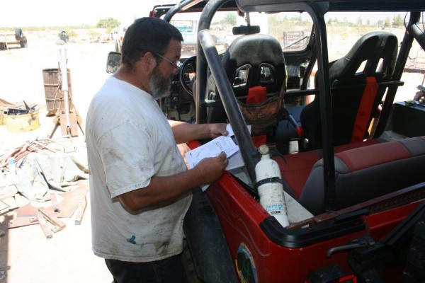 man reading a jeep cj-7 soft top installation manual