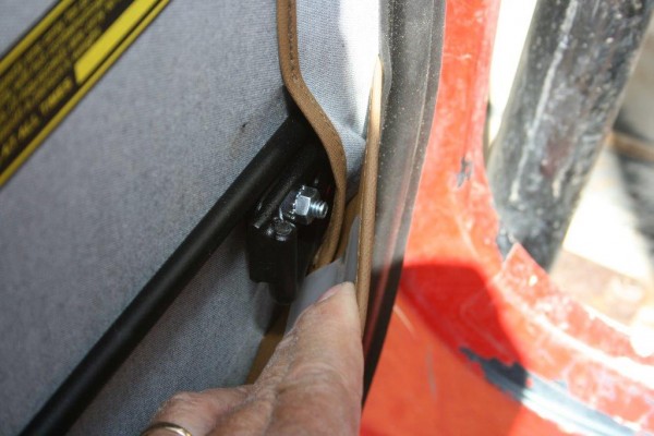 Detail shot of door handle bolt inside a jeep cj soft door frame