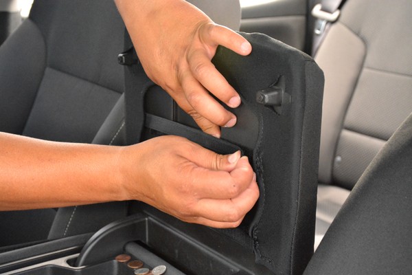 securing the Velcro strap onto a center console cover
