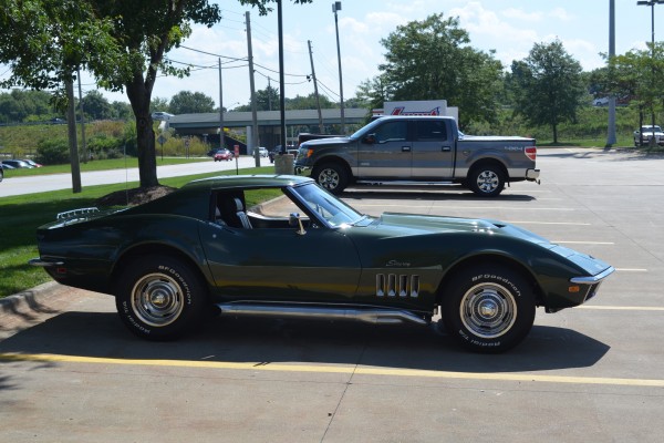 green 1969 chevy corvette stingray side profile view in parking lot