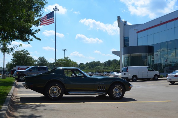 green 1969 chevy corvette stingray near American flag at summit racing in akron