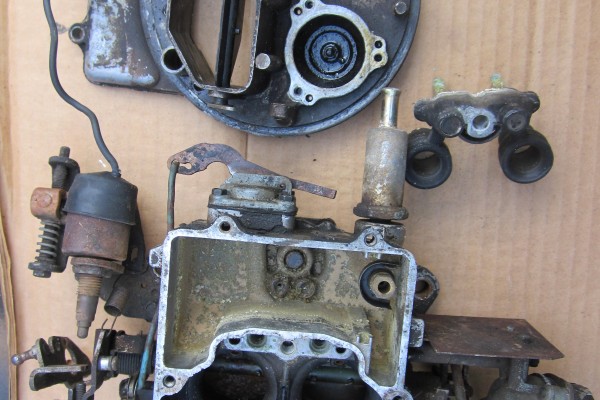 an old dirty, corroded engine carburetor