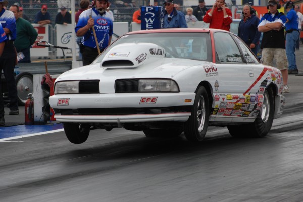 oldsmobile super modified cutlass launching at a drag strip