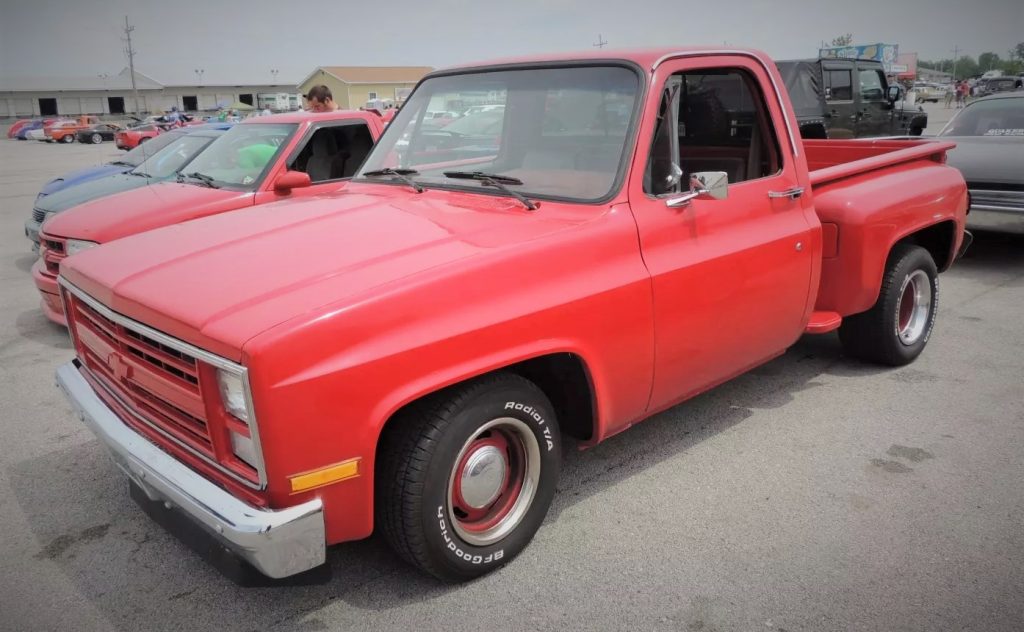 red chevy c10 squarebody pickup truck at cruise in car show