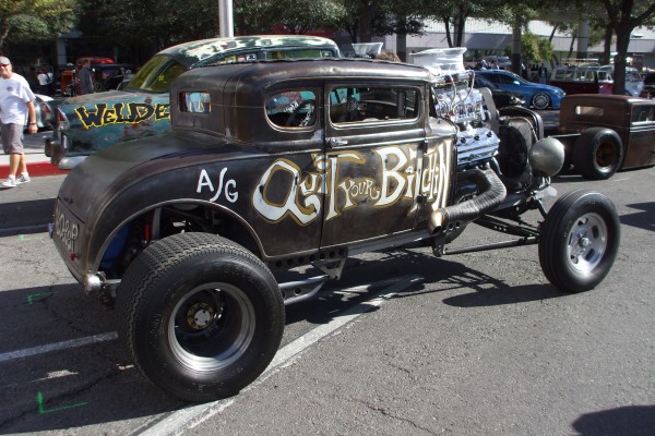 rat rod with supercharged hemi v8 engine parked on street