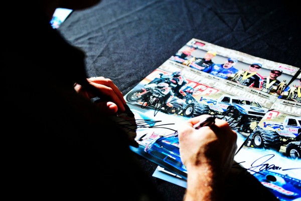 drag racer signing an autograph