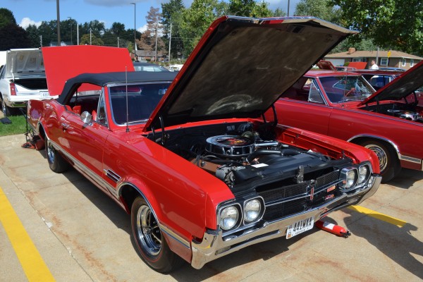 red oldsmobile 442 convertible with hood up