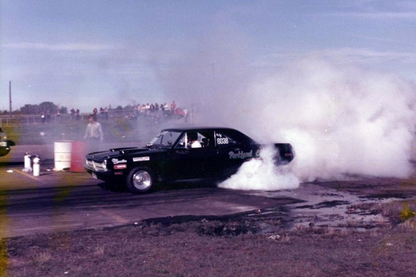 vintage photo of an old dodge dart doing a burnout prior to a drag race