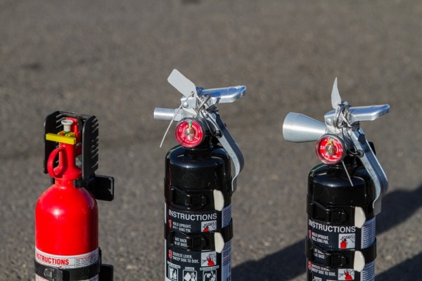 tops of three fire extinguisher bottles